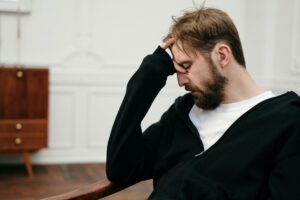 stressed man with head in hand